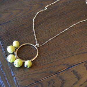 Long gold necklace with gold/yellow pendant